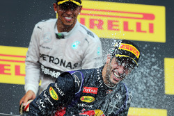 Daniel Ricciardo, Red Bull Racing celebrates with Lewis Hamilton, Mercedes AMG F1 and the champagne on the podium