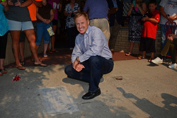 Rusty Wallace poses alongside his commemorative sidewalk plaque