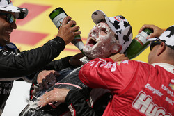 Race winner Will Power gets a face full of cream puff and champagne bath from second place Juan Pablo Montoya and third place Tony Kanaan