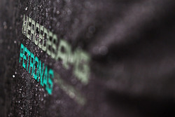 Mercedes AMG F1 logo covered in rain drops