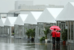 Jules Bianchi, Marussia F1 Team and Tracy Novak, Marussia F1 Team PR & Communications Director in a wet and rainy paddock