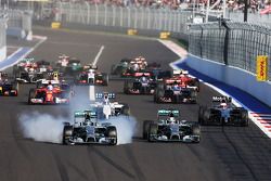 Nico Rosberg, Mercedes AMG F1 locks up under braking beside team mate Lewis Hamilton, Mercedes AMG F1 W05 at the start of the race