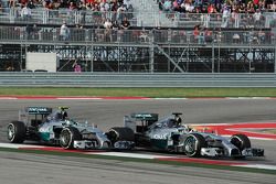 Lewis Hamilton, Mercedes AMG F1 W05 passes team mate Nico Rosberg, Mercedes AMG F1 W05 to take the lead of the race