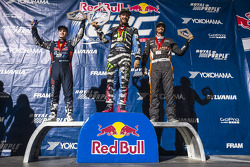 Joni Wiman, Ken Block, and Bucky Lasek celebrate on the podium after winning the Supercars class