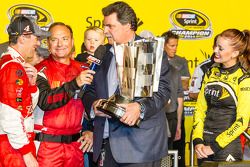 Race winner and 2014 NASCAR Sprint Cup series champion Kevin Harvick, Stewart-Haas Racing Chevrolet accepts the Sprint Cup from NASCAR President Mike Helton