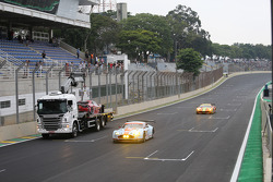 The Ferrari of Matteo Cressoni is taken away after a major crash with Mark Webber
