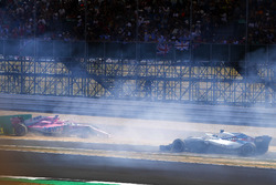 Sergio Perez, Force India VJM11, crashes into a advertising board at the start, as Lance Stroll, Williams FW41 passes by