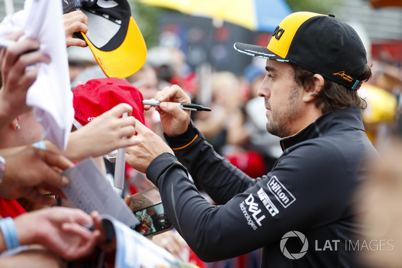 Fernando Alonso, McLaren, signs autographs for fans