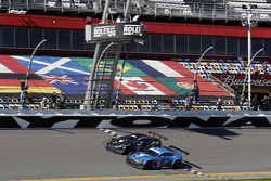 #007 TRG-AMR Aston Martin V12 Vantage: Brandon Davis, Christoffer Nygaard, Christina Nielsen, James Davison, #009 TRG-AMR Aston Martin V12 Vantage: Derek DeBoer, Max Riddle, Eliseo Salazar, Brandon Davis take the checkered flag