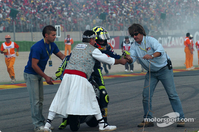 Race winner Valentino Rossi celebrates