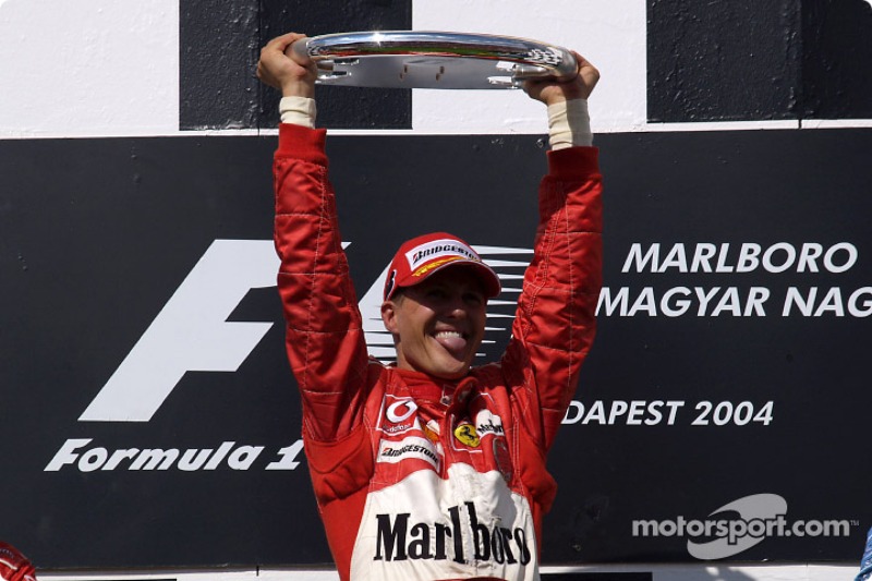 Podium: race winner Michael Schumacher celebrates