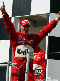 Podium: race winner Michael Schumacher celebrates