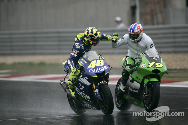 Race winner Valentino Rossi celebrates with Oliver Jacque