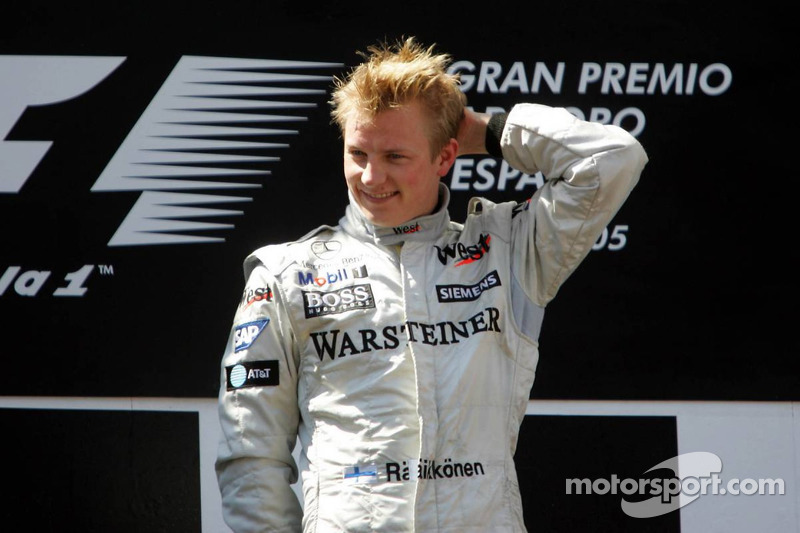 Podium: race winner Kimi Raikkonen celebrates