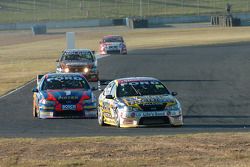 Craig Lowndes beat Marcos Ambrose out after their pit stop