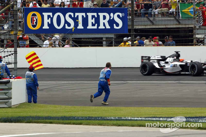 A marshall goes to recover bottles and cans of beer thrown on the track