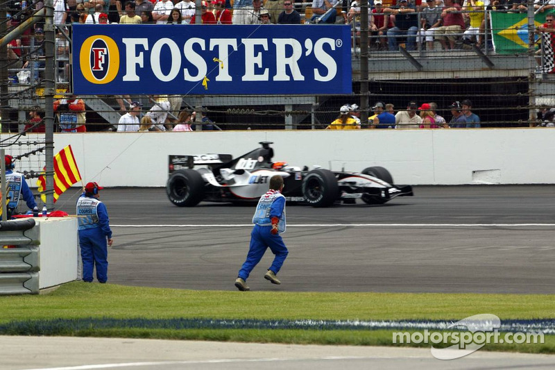 A marshall goes to recover bottles and cans of beer thrown on the track