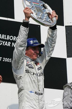 Podium: race winner Kimi Raikkonen celebrates