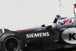 Kimi Raikkonen takes the checkered flag