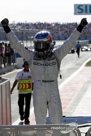 Race winner Kimi Raikkonen celebrates