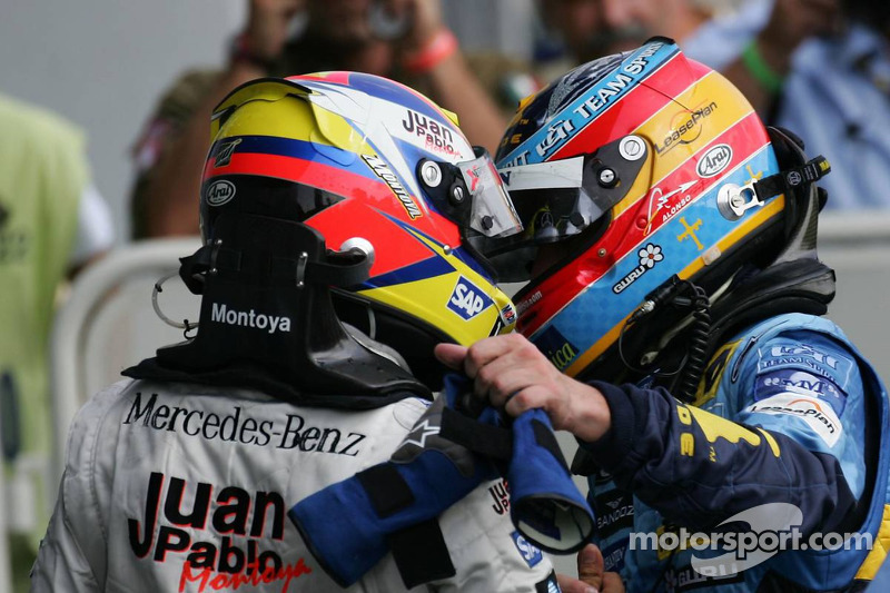 Race winner Juan Pablo Montoya celebrates with Fernando Alonso