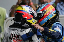Race winner Juan Pablo Montoya celebrates with Fernando Alonso