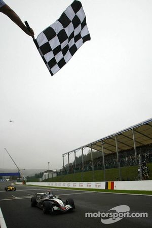 Kimi Raikkonen takes the checkered flag