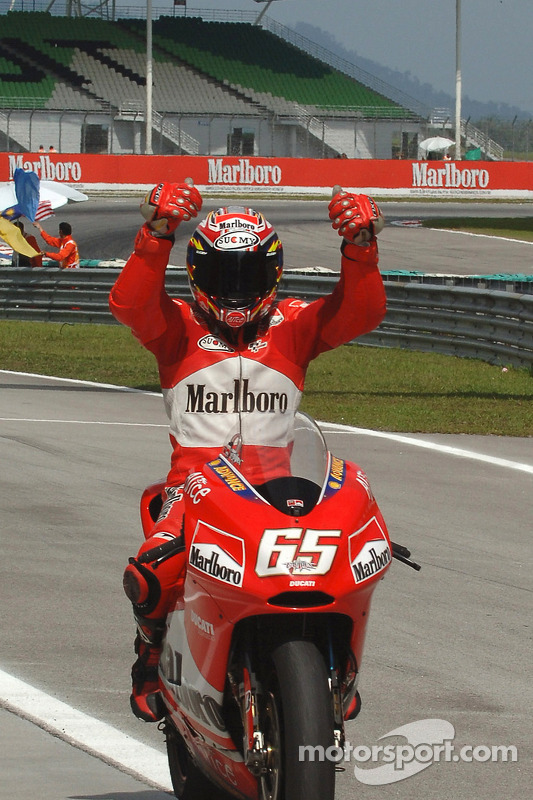 Race winner Loris Capirossi celebrates