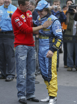 The passing of the crown: Michael Schumacher congratulates 2005 World Champion Fernando Alonso