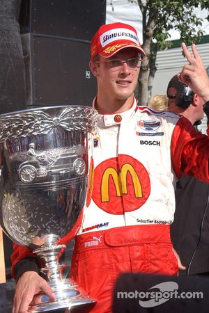 Race winner and Champ Car World Series 2005 champion Sébastien Bourdais celebrates poses with the Vanderbilt Cup