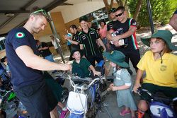 WSBK riders work on motorcycles at a local school in Australia