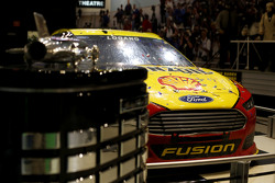 The car of Joey Logano, Team Penske Ford with the Daytona 500 trophy