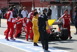 The Ferrari SF15-T of Sebastian Vettel, Ferrari is pushed down the pit lane