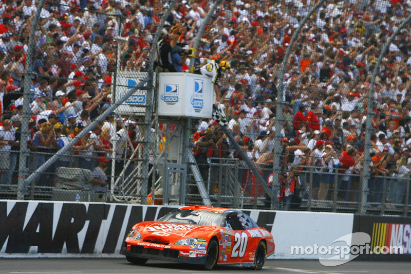 Tony Stewart takes the checkered flag