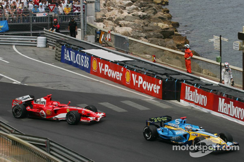 Kimi Raikkonen, right, looks, as Fernando Alonso ve Michael Schumacher pass through chicane
