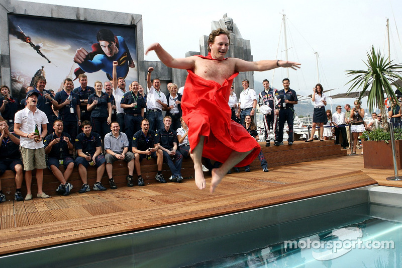 The team of Red Bull Racing and sporting director Christian Horner in a Superman cape jumps into the pool on the deck of the Red Bull Energy Station