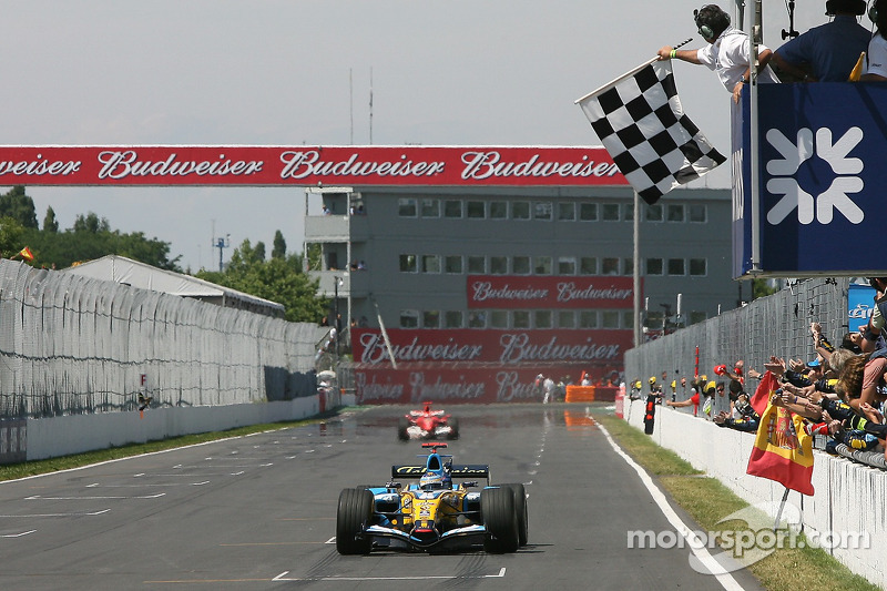 Fernando Alonso takes the checkered flag