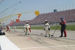 NASCAR officials keep an eye out for crew members sweeping up lug nuts