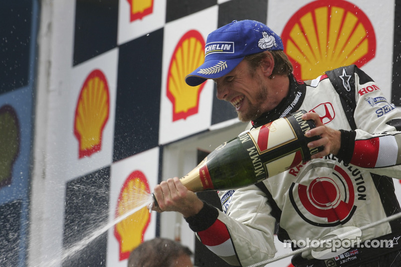 Podium: champagne for Jenson Button