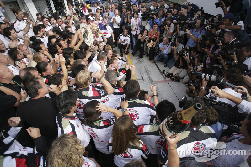 Race winner Jenson Button celebrates with Honda Racing F1 team members