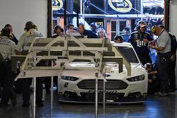 Brad Keselowski's car is inspected by NASCAR during qualifying