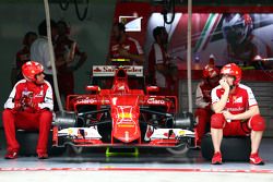 Ferrari mechanics sit by the Ferrari SF15-T of Kimi Raikkonen, Ferrari