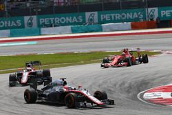 Fernando Alonso, McLaren MP4-30 leads team mate Jenson Button, McLaren MP4-30 and Kimi Raikkonen, Ferrari SF15-T, who has a puncture