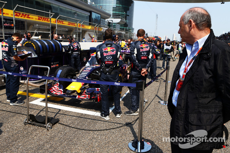 Ron Dennis, McLaren Executive Chairman looks at the Red Bull Racing RB11 on the grid