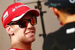 (L to R): Sebastian Vettel, Ferrari with Lewis Hamilton, Mercedes AMG F1