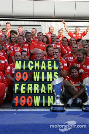 Michael Schumacher celebrates his 90th win and the 190th for Ferrari with Ferrari team members