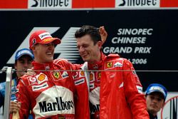 Podium: race winner Michael Schumacher celebrates with Chris Dyer