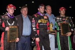 The top three finishers in the 21st Annual O'Reilly Chili Bowl Nationals including winner Tony Stewart (center), runner-up J.J. Yeley  (right) and Justin Allgaier (left) are joined by Chili Bowl co-promoters Lanny  Edwards (second from left) and Emmett Ha