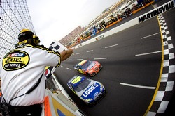 Jimmie Johnson crosses the finish line ahead of Jeff Gordon