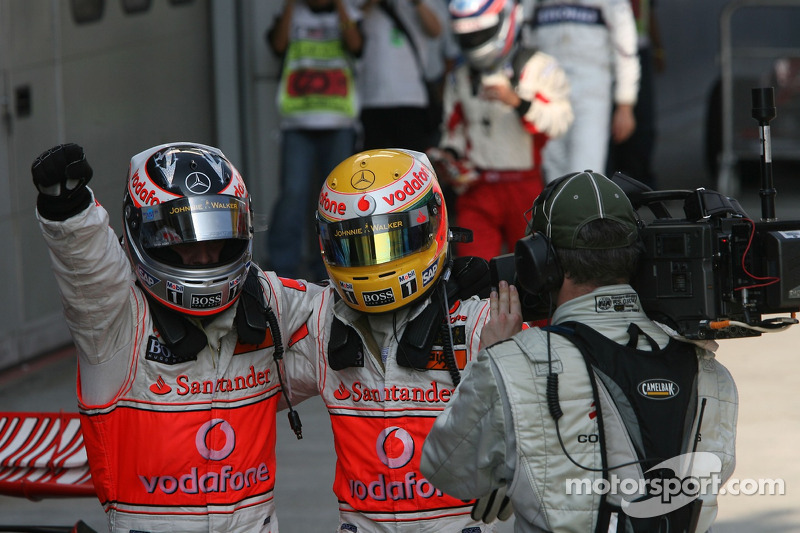 Race winner Fernando Alonso celebrates with Lewis Hamilton